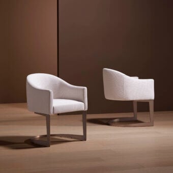 Distinctive Bellavista Corinne armchair with curved Italian poplar wood and variable-density polyurethane foam upholstered in neutral fabric, built with a unique metal base