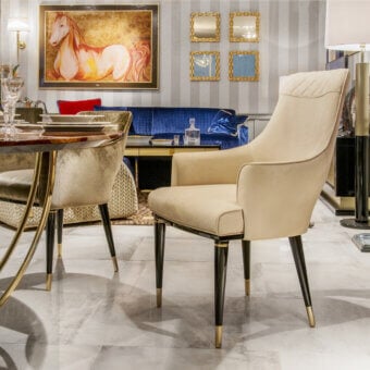 Exclusive Formitalia Dome armchair in light cream textile with quilted detailing and lacquered black legs with gold accents