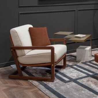 Exceptional Formitalia Enya lounge chair crafted in Italy with light cream textile upholstery and warm brown wooden finish