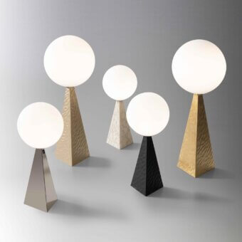 Distinguished Stillux Glo table lamp with spherical opaque white glass diffuser and gold-toned pyramidal steel base
