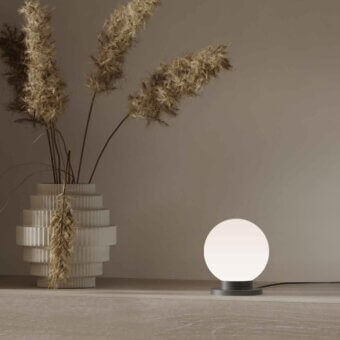 Exceptional Stillux Glo table lamp with spherical handmade matt white blown glass shade and circular matt black metal base