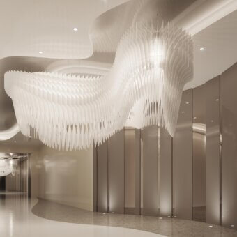Slamp Aria Infinita suspension lamp, white translucent layered design, in modern bronze interior with polished beige floor.