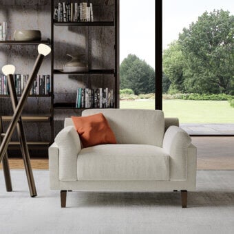 Superior Swan Italia Berry lounge chair with light beige textured fabric and contrasting orange feather cushions crafted with a burnished metal frame