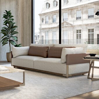 Distinguished Turri Drum sofa with light beige textile upholstery and rich brown leather cushions, built with a walnut wood frame and bronze details
