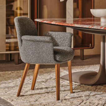 Superior Turri Soul armchair with gray textured textile upholstery and light brown walnut wood legs