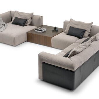 Exceptional Turri Soul sectional with light beige textile upholstery, dark gray base panels and leather armrest inserts