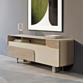 Elegant Turri Soul sideboard with distinctive metal frame and wood inserts against a cream-colored body showcasing rounded front details