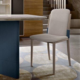 Distinguished Turri Zero chair with light beige textile and lacquered wooden legs, accented with navy blue and a metal insert