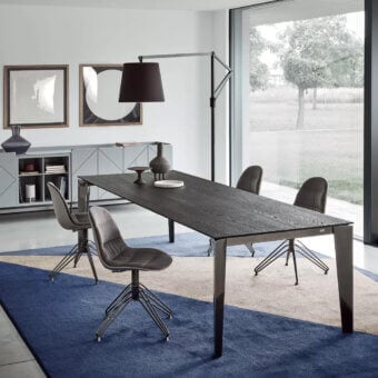 Elegant Bontempi Cruz extendable table with dark textured wood tabletop and glossy metal supporting legs