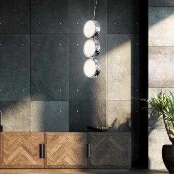 Distinguished Stillux Circle suspension lamp with vertically aligned matt white glass diffusers and hammered metal framing