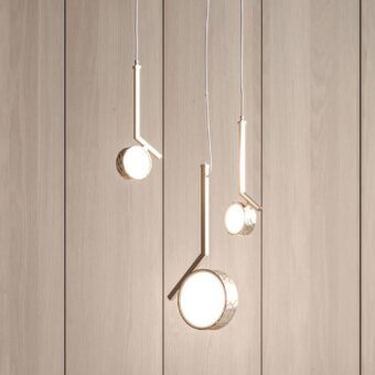 Superior Stillux Circle suspension lamp with a hammered metal frame and matt white glass diffuser emitting a soft glow