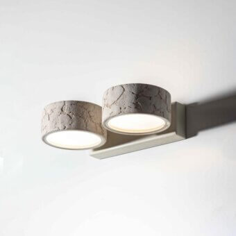 Superior Stillux Circle wall lamp with adjacent cylindrical matt white glass diffusers and refined stone frame