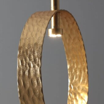 Distinguished Stillux Eclipse suspension lamp with a hammered metal ring and gold finish creating enveloping brightness