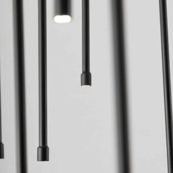 Distinguished Stillux Flow suspension lamp with a circular structure and dynamic matte black metal pendants providing warm white illumination