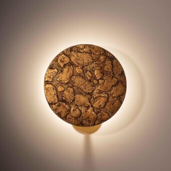 Exceptional Stillux Orbis wall lamp sculpted in earthy stone with a textured, irregular pattern and mix of browns and gold