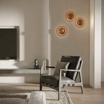 Elegant Stillux Orbis wall lamp crafted in warm copper tone with a rustic hammered metal surface