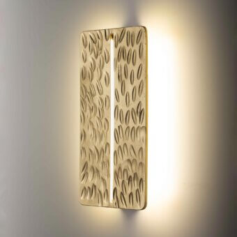 Superior Stillux Random wall lamp with a golden hammered metal frame and raised oblong shapes emitting white light