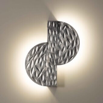 Distinctive Stillux Random wall lamp with a hammered metal frame and soft ambient light, exhibiting a textured matte finish