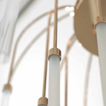 Distinguished Stillux Line ceiling lamp with a glossy gold metal structure and thirty curved arms supporting tubular frosted pyrex glass diffusers