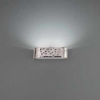 Elegant Stillux Shape wall lamp crafted in Italy with a reflective hammered metal frame and upward glow