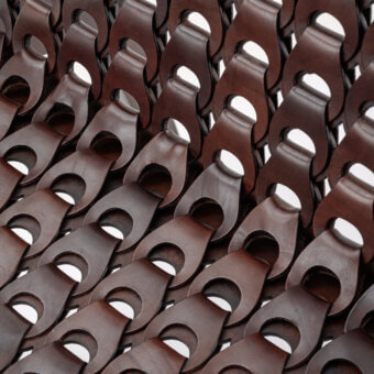 Distinguished Turri Net Lounge Chair with woven saddle leather and walnut wood structure crafted in Italy