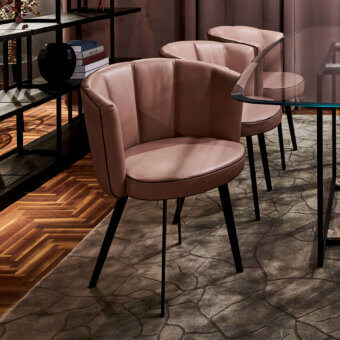 Distinguished Borzalino Diva chair showcases dusky rose leather upholstery with dark piping and a matte black lacquered metal base