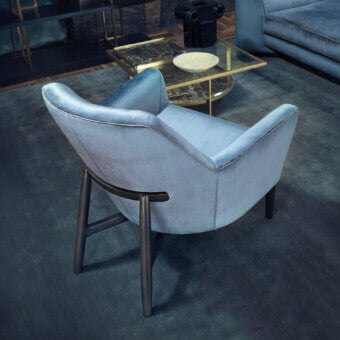 Elegant Borzalino Eve Plus lounge chair with light blue textile upholstery and lacquered oak base