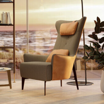 Borzalino Mia lounge chair, gray textured fabric, high backrest with tan suede armrests and dark wood tapered legs in modern interior.