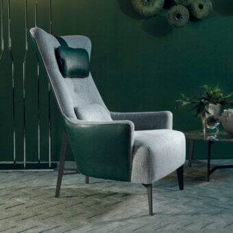 Elegant Borzalino Mia lounge chair with light gray textile and dark green leather detailing in powder coating finish