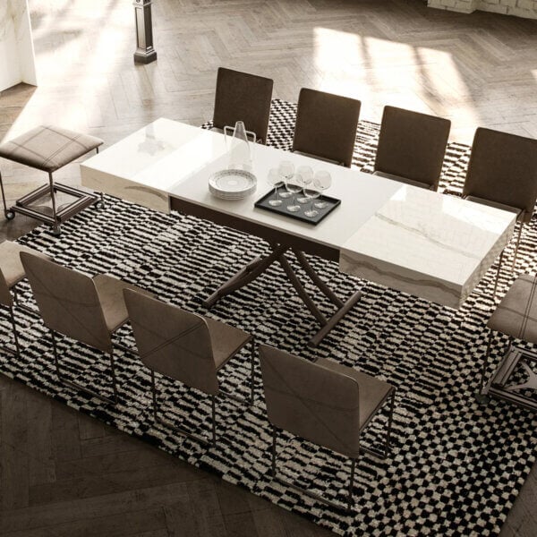 Dining table with white marble top and dark metal base, surrounded by eight brown upholstered chairs on a patterned rug.