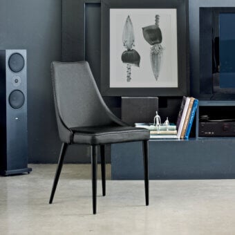 Superior Bontempi Clara chair with dark synthetic leather upholstery and slender black metal legs exhibiting a matte finish