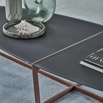 Distinctive Bontempi Cross coffee table with dark gray tabletop and warm copper metal X-shaped base