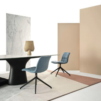 Distinguished Bontempi Kuga chair with light blue textile upholstery and dark metal base, crafted in a sleek silhouette with button-tufted back