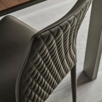 Superior Bontempi Nata chair with quilted dark gray leather-like material and curved ergonomic design