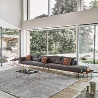 Elegant Bontempi Tokio coffee table with a curved copper tone metal frame and transparent tabletop crafted in Italy