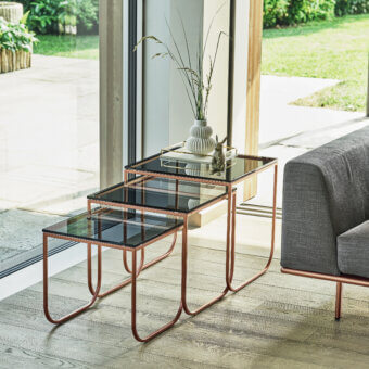 Elegant Bontempi Tokio nested tables with curved metal frames and dark tinted glass tops in copper or rose gold finish