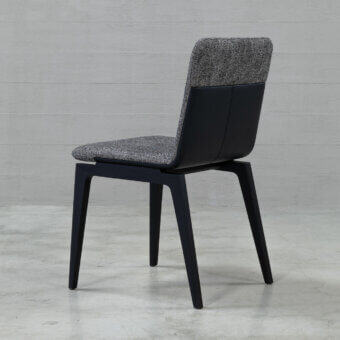 Distinguished Cierre1972 Marlon chair with textured gray textile upholstery and dark wooden legs offering a balanced aesthetic