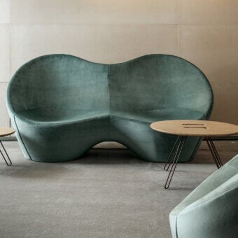 Distinguished Casamania Kouch sofa presents voluptuous ergonomic form upholstered in premium teal fabric with matte finish