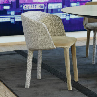 Exceptional Casamania Lepel armchair with swirling patterned legs and solid light brown fabric upholstery