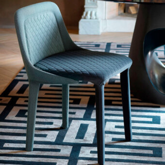 Exceptional Casamania Lepel chair upholstered in muted blue-gray fabric with quilted diamond patterning and contrasting legs