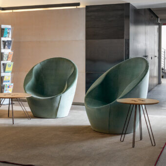 Exceptional Casamania Ouch lounge chair presents a voluptuous silhouette upholstered in matte muted green textile with internal metal structure