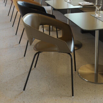 Luxury Casamania Vad armchair crafted in light brown leather with smooth finish and black metal legs