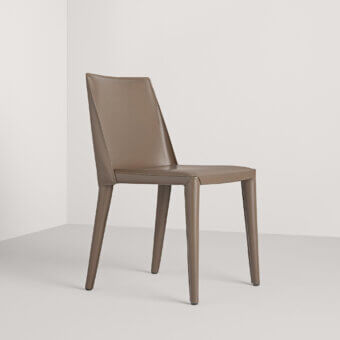 Elegant Frag Dindi chair fully upholstered in luxurious saddle leather with a flexible spring steel back and minimalist tapered legs