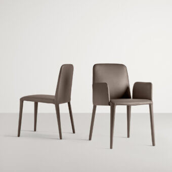 Distinguished Frag Elf chair presents sleek lines with full dark brown leather upholstery and a flexible back built in Italy