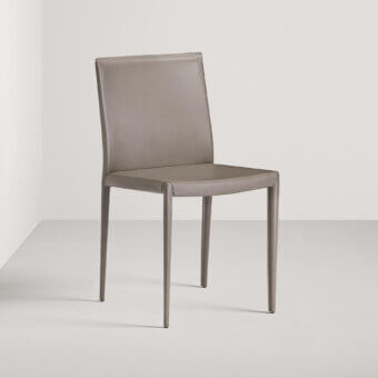 Distinguished Frag Lilly chair with light gray upholstery in Leather or Saddle Leather and ornate rear seams