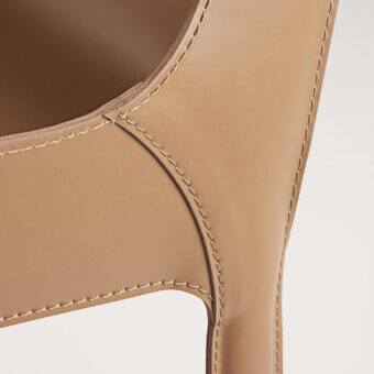 Sophisticated Frag Nisida chair upholstered in light tan Saddle Leather with decorative stitching and metal frame