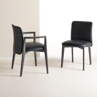 Superior Frag Siloe chair with dark upholstered seat and backrest, built with a smooth matte wood frame and graceful curving legs