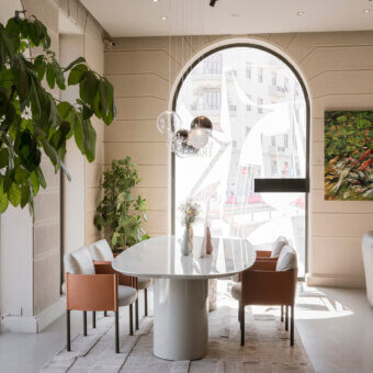 Distinguished Frag Syren armchair exhibits a boxy design with a light-brown matte frame supporting white textile cushions