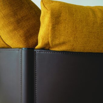 Distinguished Frag Syren lounge chair crafted with tubular metal and lavish yellow cushions against matte brown leather