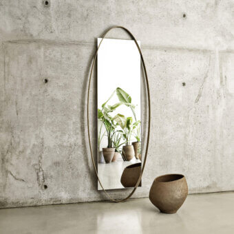 Exclusive Frag Twin Mirror with elongated oval metal profile and matte bronze toned reflective surface